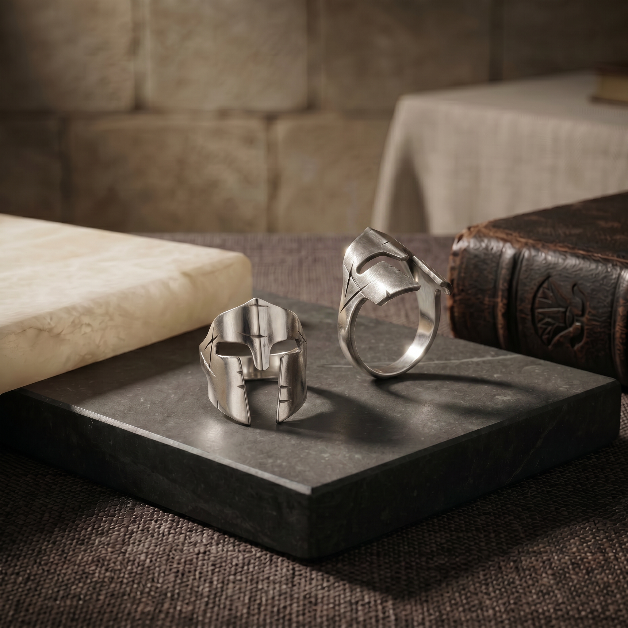 Handcrafted Spartan 925 sterling silver rings displayed on a dark marble surface with refined masculine styling, designed as a timeless luxury silver gift by Saad of Egypt.