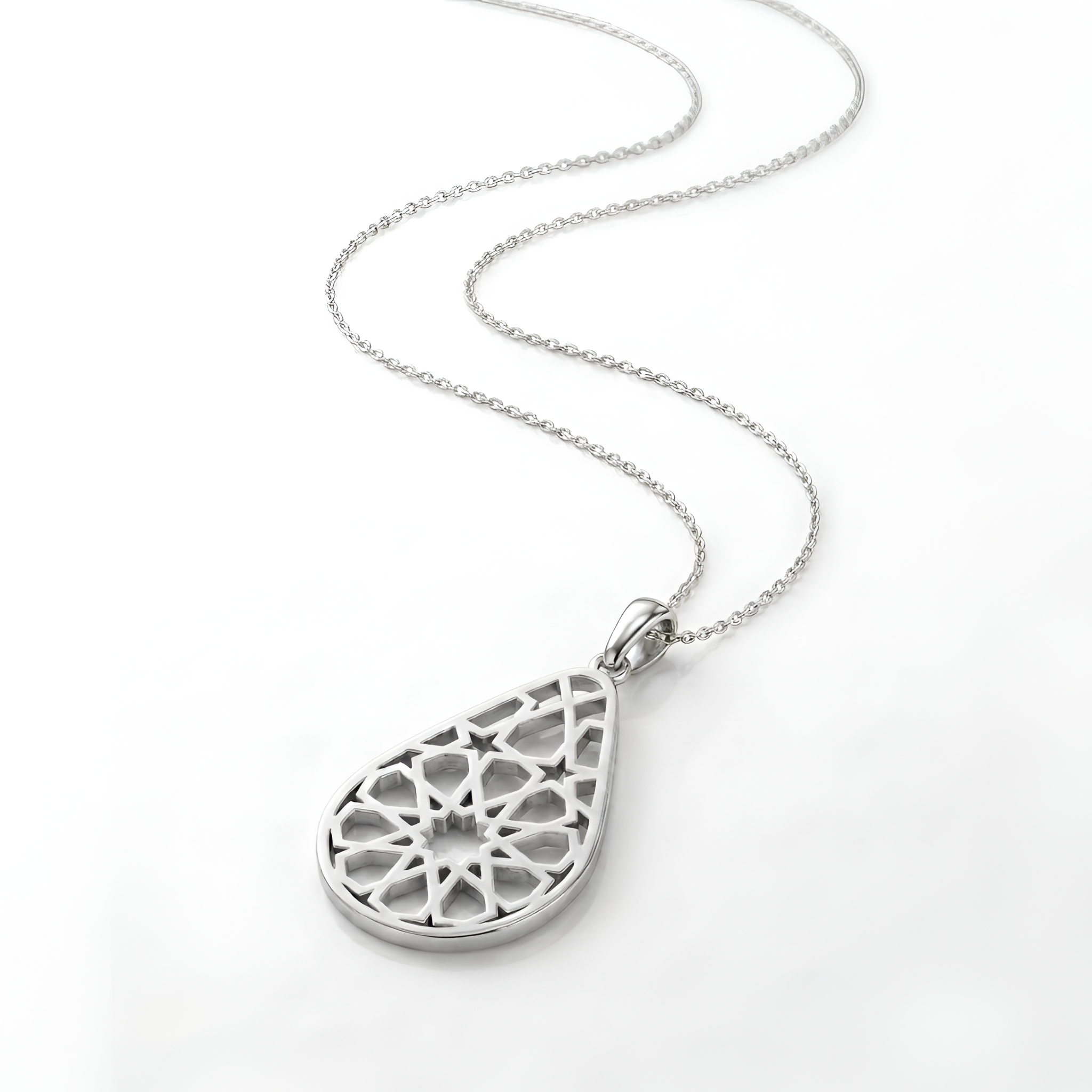 Close-up angled view of an elegant handcrafted 925 sterling silver arabesque drop pendant necklace showcasing intricate geometric filigree-inspired detailing, created for refined styling, timeless sophistication, and luxury silver gift by Saad of Egypt.