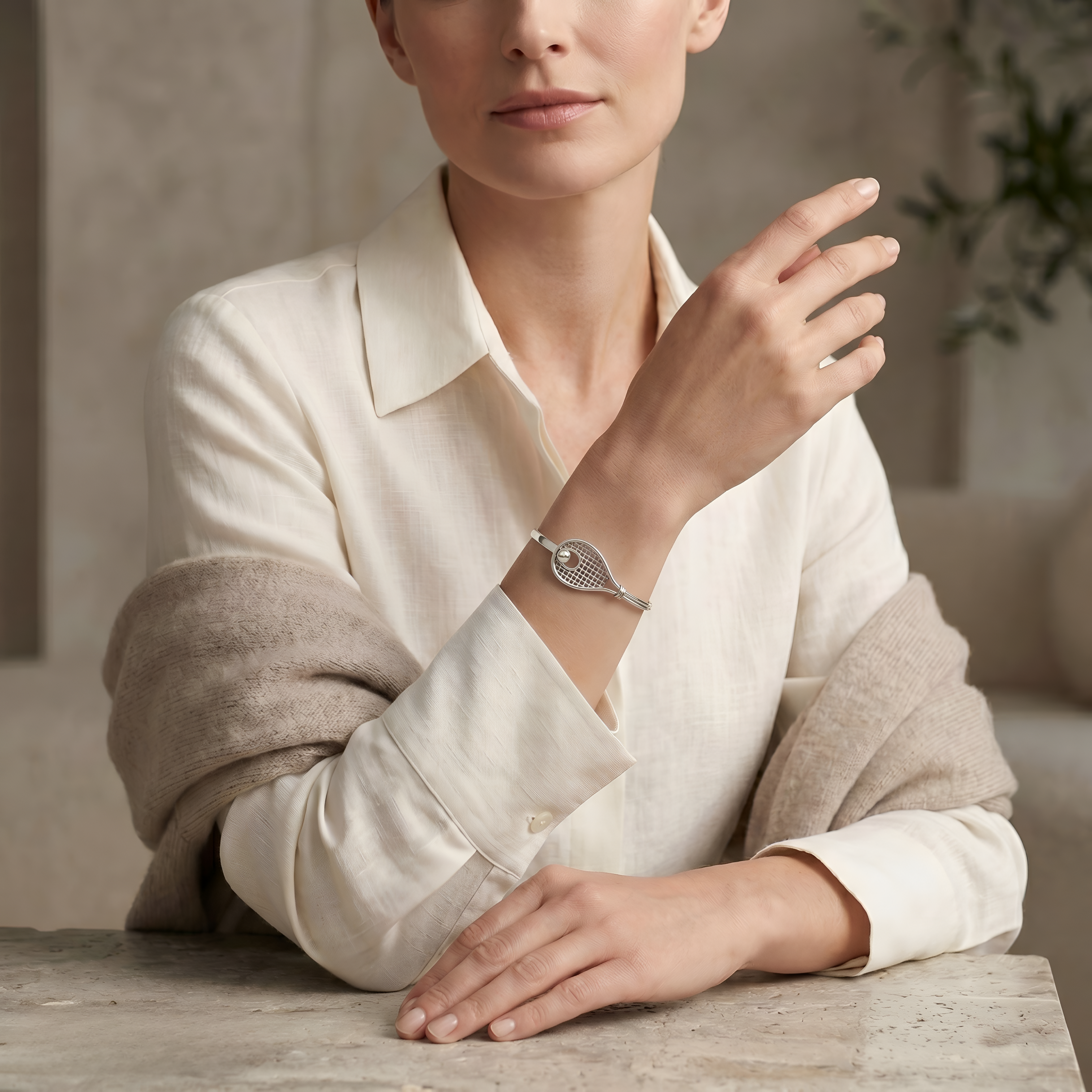 Elegant woman styling a handcrafted 925 sterling silver tennis racket bangle from Saad of Egypt, a refined jewelry piece that blends sporty inspiration with modern sophistication for everyday wear or thoughtful gifting.
