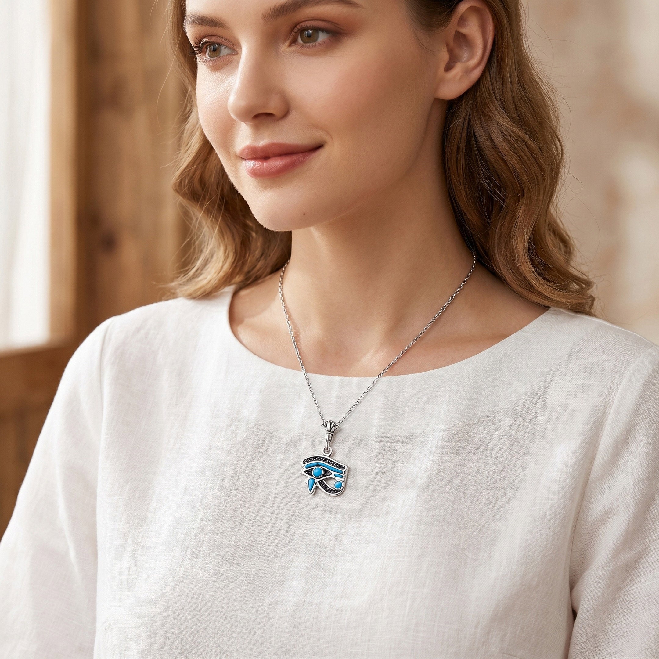 Calm refined portrait of a woman wearing a handcrafted 925 sterling silver filigree Eye of Horus turquoise pendant, an elegant women gift reflecting serenity and timeless beauty by Saad of Egypt.