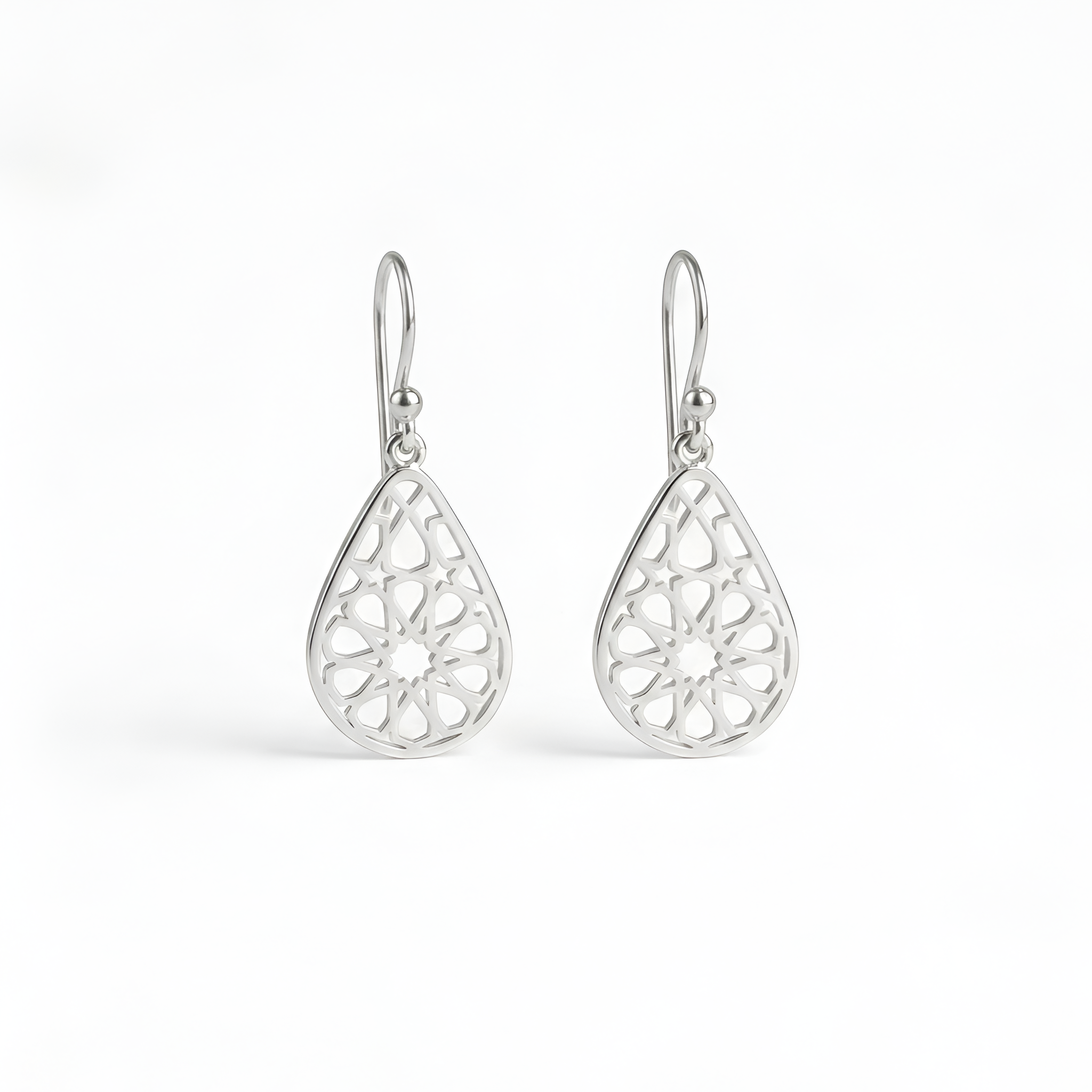 Elegant handcrafted 925 sterling silver arabesque drop earrings featuring delicate geometric cutout detailing inspired by classic oriental artistry, designed for timeless feminine elegance, sophisticated styling, and luxurious silver gift collections by Saad of Egypt.