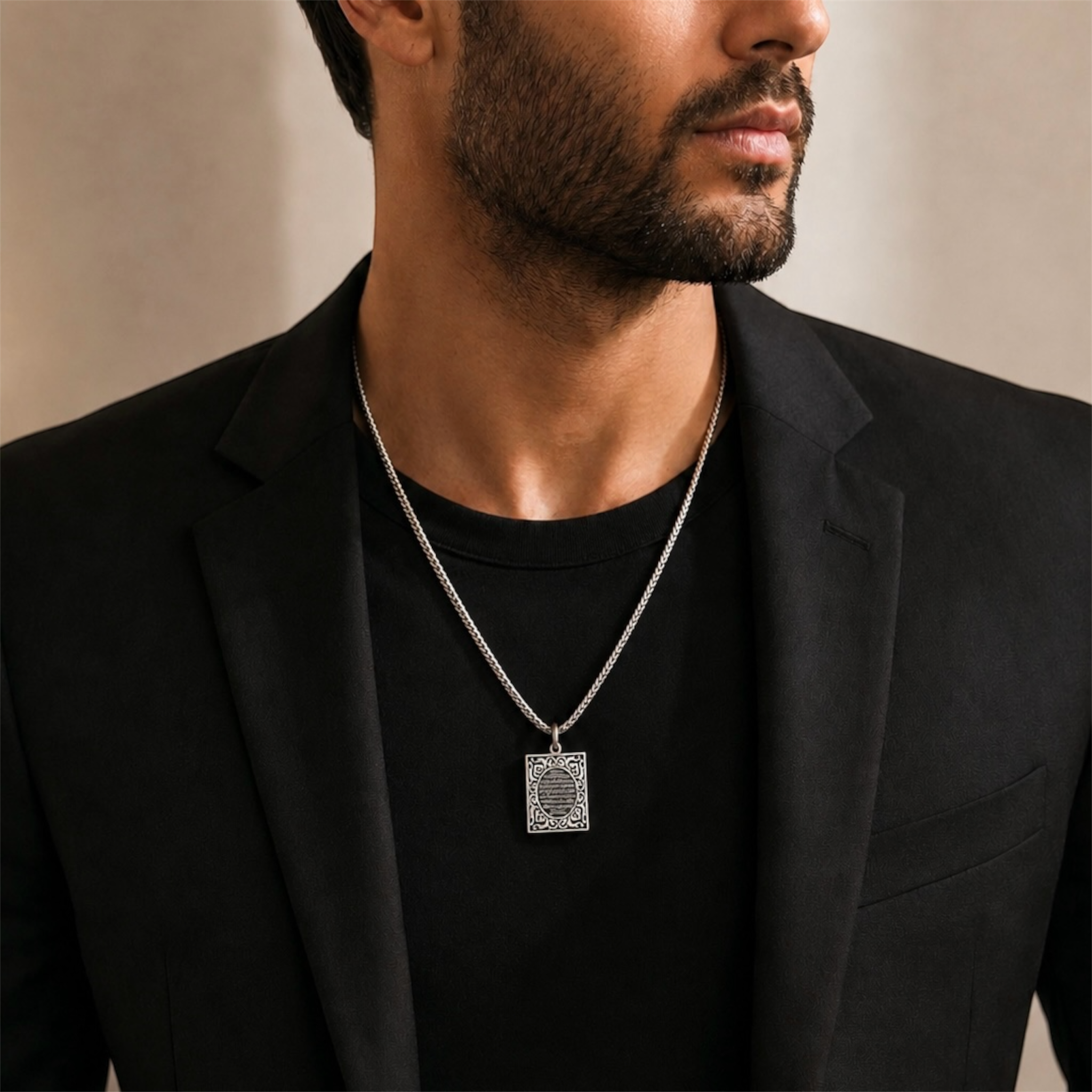 Luxury men’s lifestyle image featuring handcrafted Ayat Al Kursi pendant in 925 sterling silver with refined Islamic engraving and timeless artisanal craftsmanship. Elegant handmade statement pendant by Saad of Egypt.