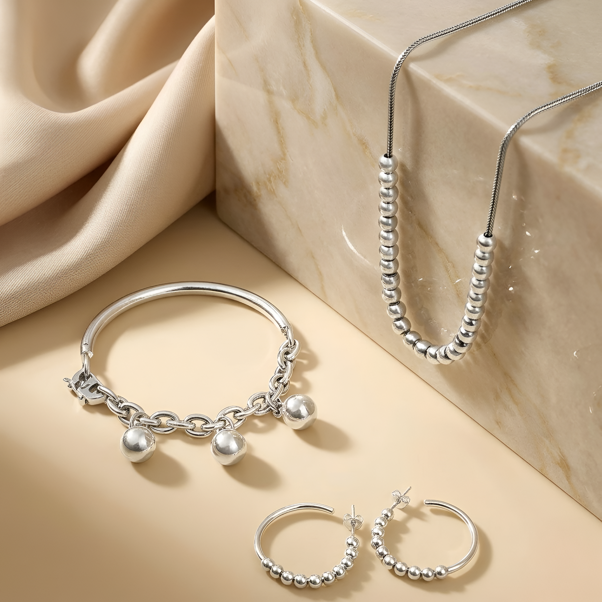 Polished 925 sterling silver jewelry set composed of delicate spherical elements, creating a soft reflective shine and a timeless feminine appeal, a graceful jewelry gift for women by Saad of Egypt