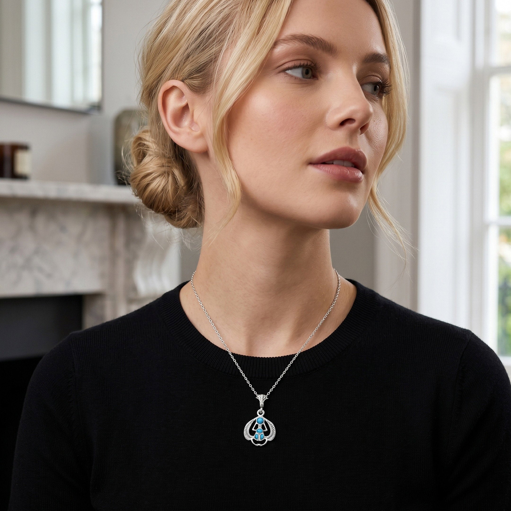 Lifestyle image of a woman wearing a handcrafted 925 sterling silver flying scarab turquoise pendant, designed as a refined women’s jewelry gift by Saad of Egypt.