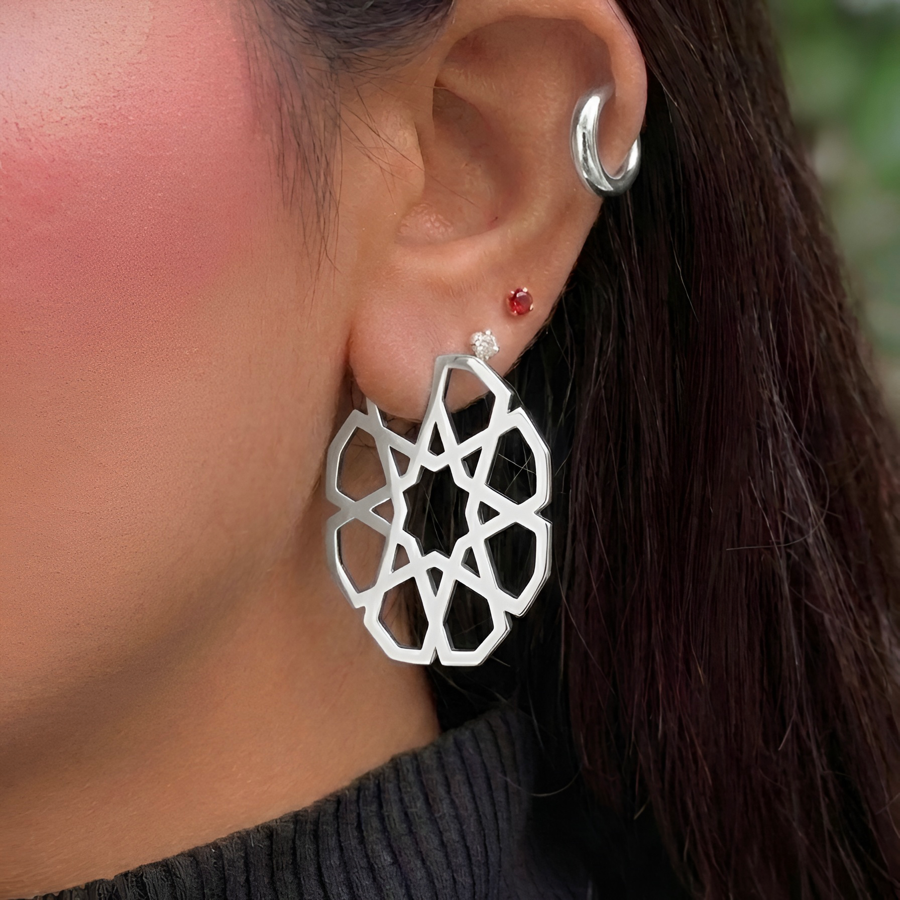 Lifestyle handcrafted 925 sterling silver Naggary earrings by Saad of Egypt, worn as a bold statement jewelry piece featuring geometric Arabic-inspired detailing, an elegant modern accessory and meaningful gift for women.